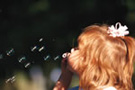 Young girl blowing bubbles